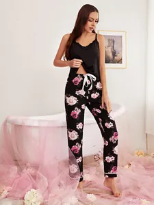 Detail of women's two-piece pajama set with black lace camisole and floral pants