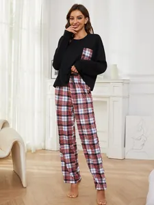 Detailed view of women's two-piece plaid pajama set in a cozy home setting