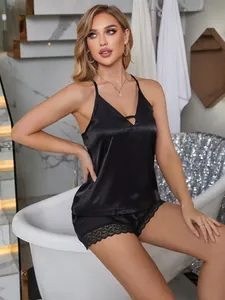 Elegant black satin camisole pajama set for women featuring delicate lace trim shorts