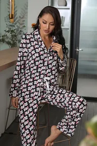 Close-up detail of the floral print and white piping on the women's pajama set.