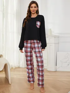Women's plaid pajama set with black long-sleeve top and matching plaid pants