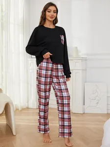 Cozy women's two-piece pajama set with black long sleeve top and red plaid pants