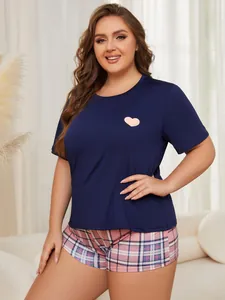 Detailed view of women's plus size navy blue heart tee and pink plaid pajama shorts