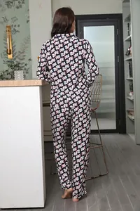 Back view of stylish women's floral pajama set featuring long-sleeved top and long pants.