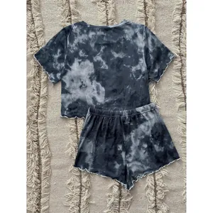 Women's stylish summer two-piece tie-dye pajama set with ruffled hem edges on a rug