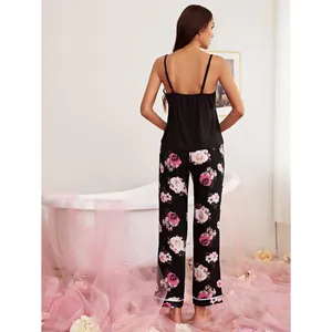 Sexy two-piece women's pajama set with black cami top and pink rose floral long pants