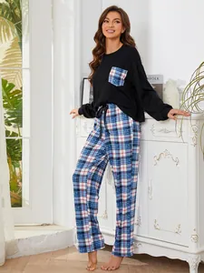 Casual women's black top and plaid pants pajama set for autumn and winter home wear.