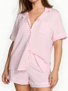 Close-up of pink striped short sleeve pajama set with button-up shirt and shorts