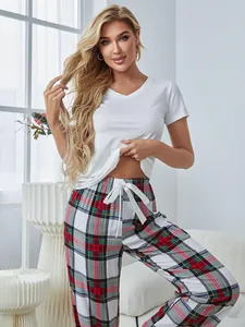 Blondes Model trägt ein weißes V-Shirt und eine rot karierte Schlafanzughose Set.