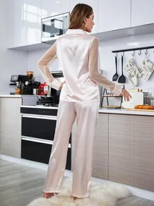 Back view of pink satin pajama set featuring elegant mesh dot detailed long sleeves