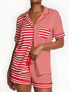 Two-piece red and white striped pajama set with short sleeves and shorts on a model