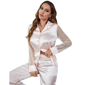 Detail of pink satin pajama top featuring sheer polka dot mesh sleeves for women.