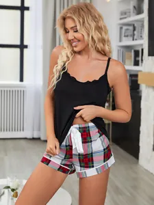 Close-up of black lace cami top and plaid shorts pajama set for women