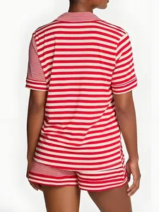 Back view of women's red and white striped pajama set with short sleeves and shorts