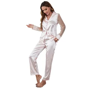 Detail shot of pink satin pajama set featuring sheer mesh polka dot long sleeves