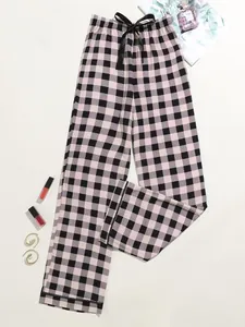 Fashionable black and white checkered pajama pants for women featuring a black bow drawstring