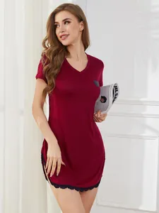 Detailed shot of burgundy V-neck nightdress with heart print and delicate black lace hem