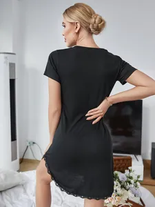 Back view detail of a black short-sleeved nightgown featuring a delicate lace hem trim
