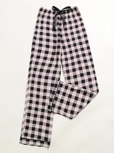 Close-up detail of women's pink and black checkered pajama pants with a black drawstring