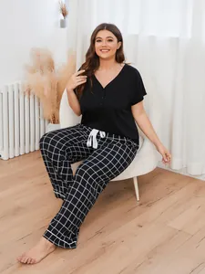 Close-up of women's plus size pajama set featuring a V-neck top and plaid long pants