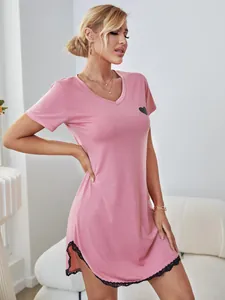 Detailed macro view of pink nightdress featuring black heart print and lace hem decoration