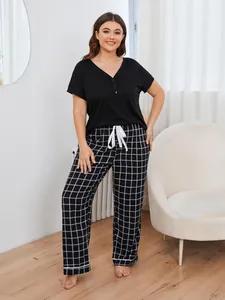 Two-piece plus size pajama set featuring black short sleeve top and checkered pants