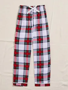 Close-up detail of women's colorful plaid pajama pants featuring a white satin bow