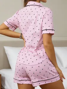 Back view of women's pink striped short pajama set featuring black bird patterns.