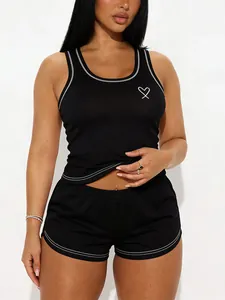Black women's pajama set with white contrast stitching and heart detail on tank top
