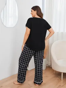 Full back view of comfortable plus size women's pajama set with black top and plaid pants