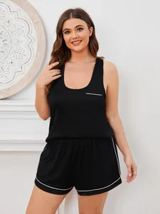 Detailansicht eines schwarzen Plus-Size-Schlafanzugs mit Top, Shorts und weißen Paspeln