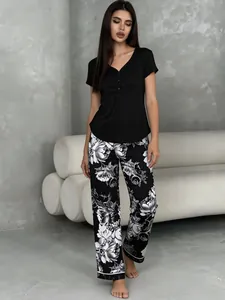 Women's pajama set featuring a black v-neck top and floral print long lounge pants