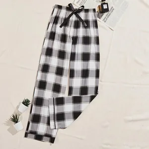 Cozy women's black and white buffalo plaid pajama pants with an adjustable drawstring waist