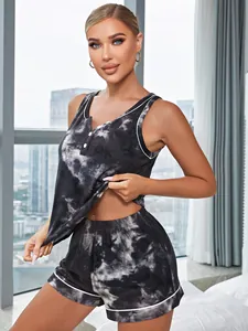 Detail view of tie-dye pajama set with button tank top and piping shorts