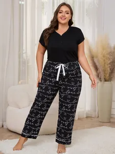 Full view of plus size women's pajama set featuring short sleeve top and heart print pants