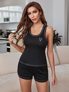 Women's black casual pajama set featuring a heart print tank top and matching shorts