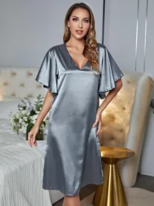 Elegant grey satin nightgown with V-neck and flutter sleeves in a cozy bedroom setting.
