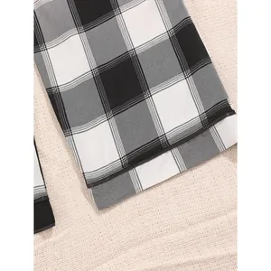 Women's black and white checkered pajama pants with straight leg design