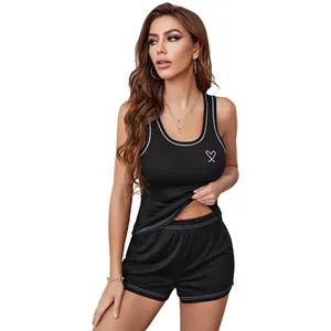 Women's black pajama set featuring tank top and shorts with white heart embroidery