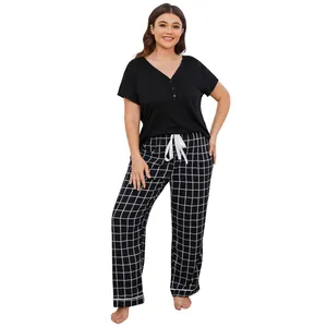 Plus size women's pajama set featuring black short sleeve top and plaid long pants.
