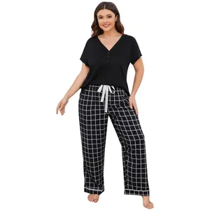 Close-up of plus size women's pajama set featuring black V-neck top and grid pants.