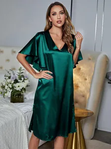 Elegant dark green satin V-neck nightgown with flutter sleeves in a bedroom setting