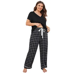 Women's plus size two-piece pajama set with black short-sleeve top and checkered pants