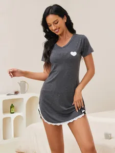 Close-up of a grey V-neck nightgown featuring a white heart print and delicate lace trim