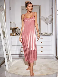 Full view of elegant pink striped silk satin slip nightgown in a chic room setting