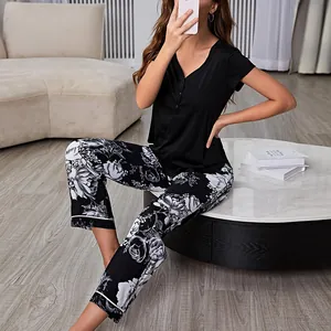 Women's two-piece pajama set with black short sleeve top and floral print pants