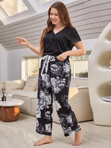 Detailed view of a plus size women's pajama set featuring a black top and floral pants