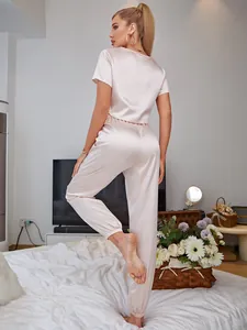 Back view of pink satin pajama set with short sleeves and jogger pants for women