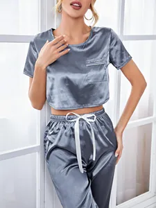 Detailed view of grey blue satin pajama set with short sleeve crop top and jogger pants