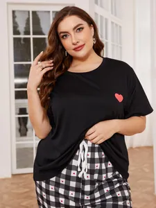 Detail shot of plus size women's pajama set with black heart top and plaid pants